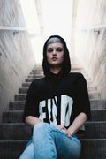 Model in a black and white hoodie on the street